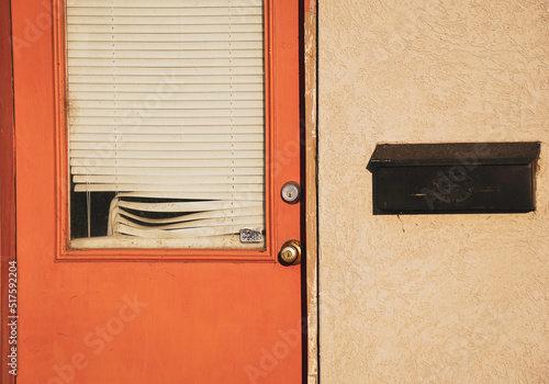 Bilde på lerret Orange urban door on rundown building with broken blinds