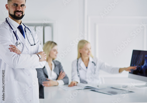 Happy doctor with medical staff at the hospital