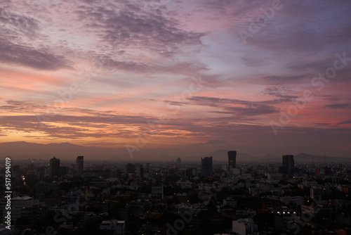 panoramic photo of a beautiful sunrise in mexico city with volcanos in the background (Iztaccíhuatl, popocatepetl).