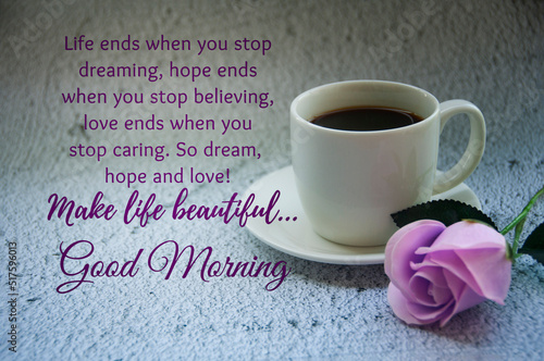 Morning wishes text and motivational quote about life. With coffee cup and flower background.