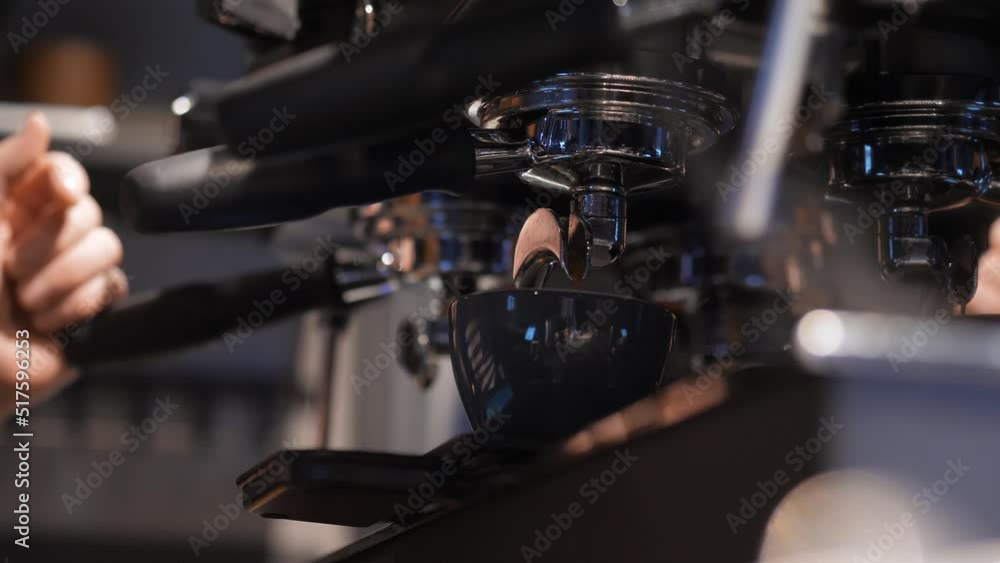 Unrecognizable barista making hot coffee in coffee shop. Process of preparing cup of coffee in coffee machine, close up Unrecognizable barista making hot coffee in coffee shop. Process of preparing cup of coffee in coffee machine, close up
