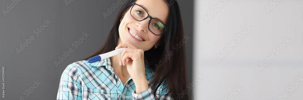 Young happy female hold pregnancy test, female got big news and smiling Young happy female hold pregnancy test, female got big news and smiling
