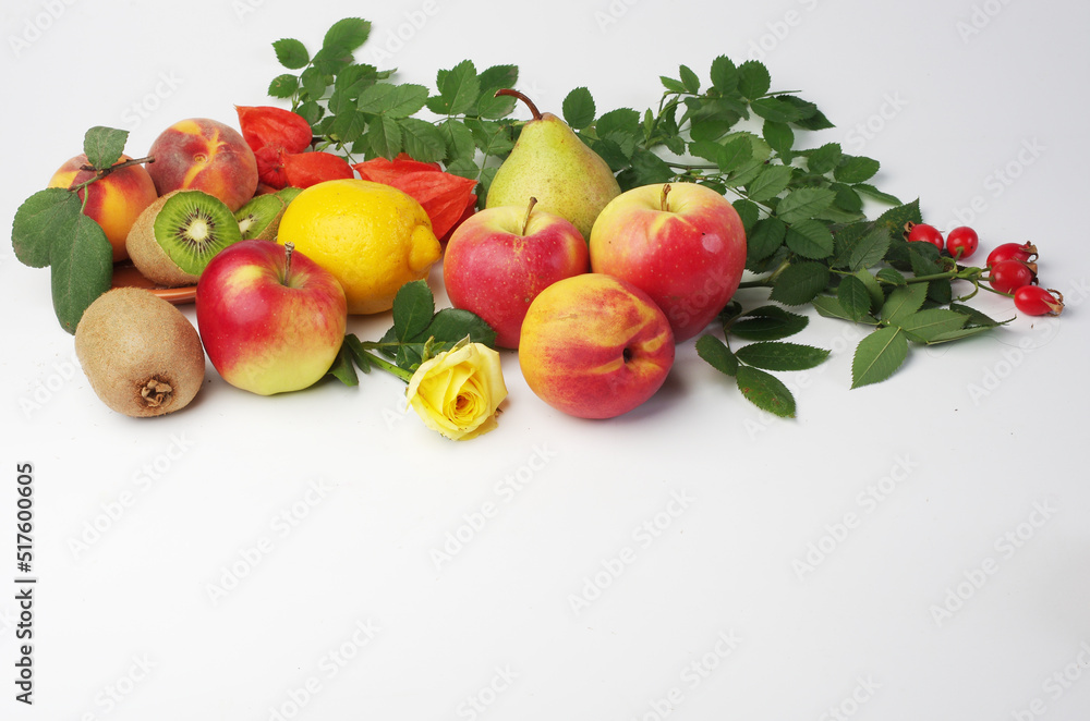 Fresh fruits apples, peaches, kiwi and leaves on a white background. Fresh fruits apples, peaches, kiwi and leaves on a white background.