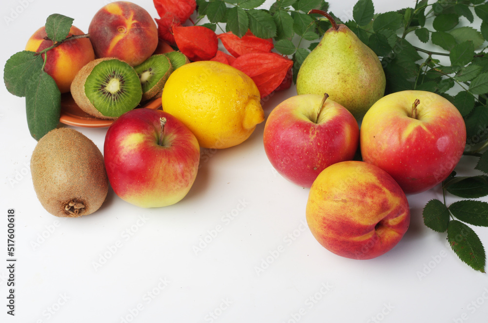 Fresh fruits apples, peaches, kiwi and leaves on a white background. Fresh fruits apples, peaches, kiwi and leaves on a white background.