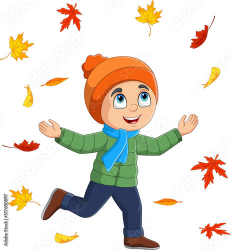 Cartoon little boy throwing autumn leaves