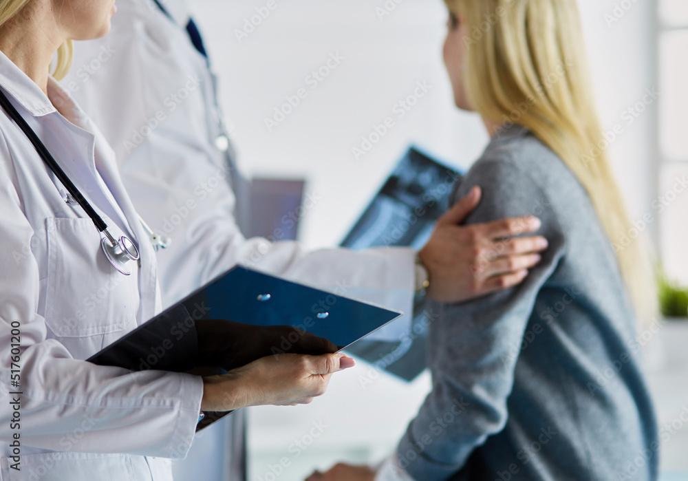 Doctor and patient discussing scan results in diagnostic center Doctor and patient discussing scan results in diagnostic center