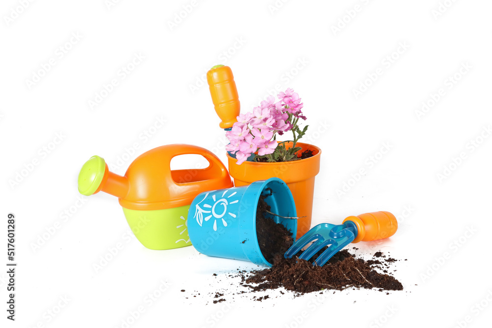 gardening toy for children with a small shovel, a watering can and a pot with a flower and soil 
