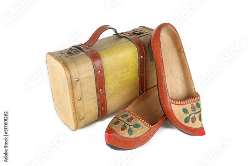 old wooden suit case with pair of wooden shoes isolated on a white background  photo