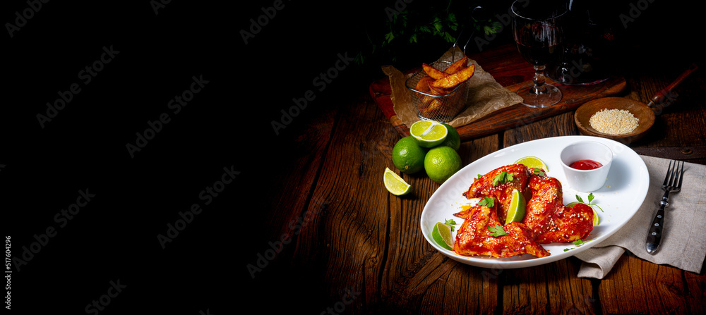 chicken wings with potato wedges and sezam. - obrazy, fototapety, plakaty 