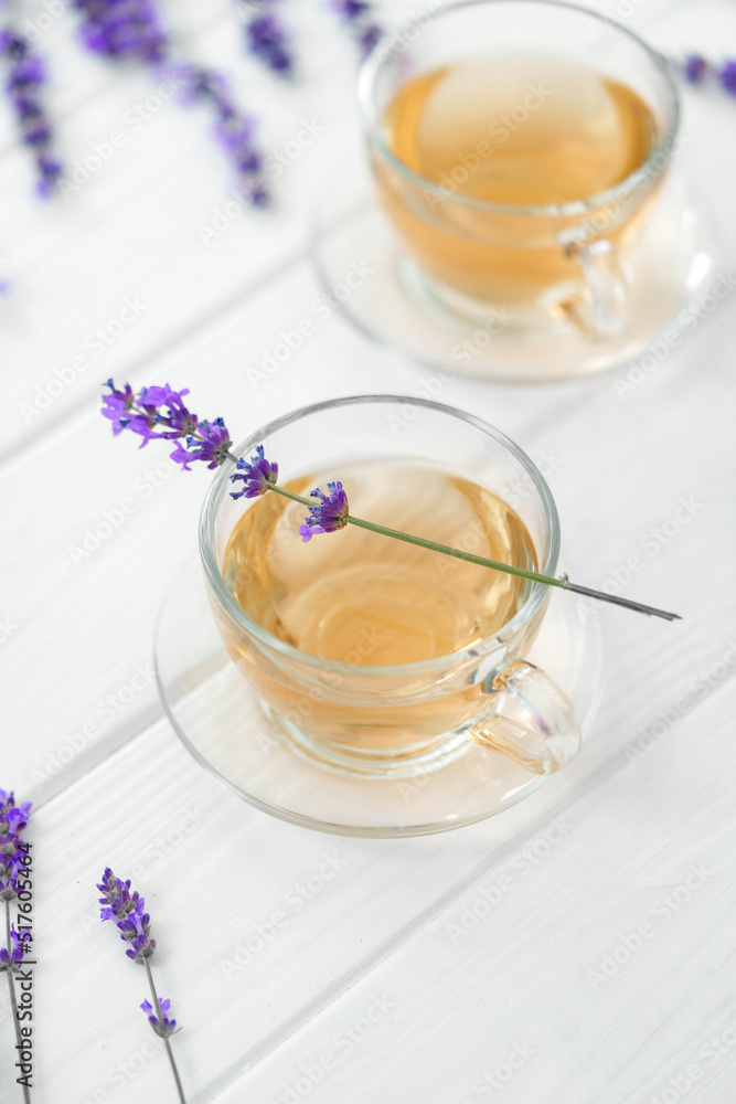 Cup with lavender tea and lavender flowers on wooden backgorund. Cup with lavender tea and lavender flowers on wooden backgorund.