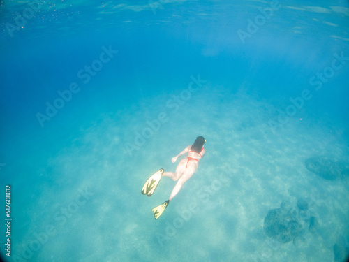 woman swimming underwater in flippers and scuba mask