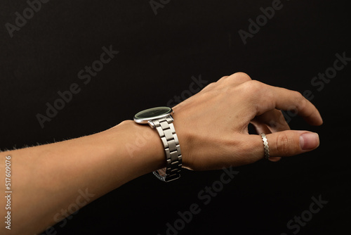 A girl tries on a hand watch in silver