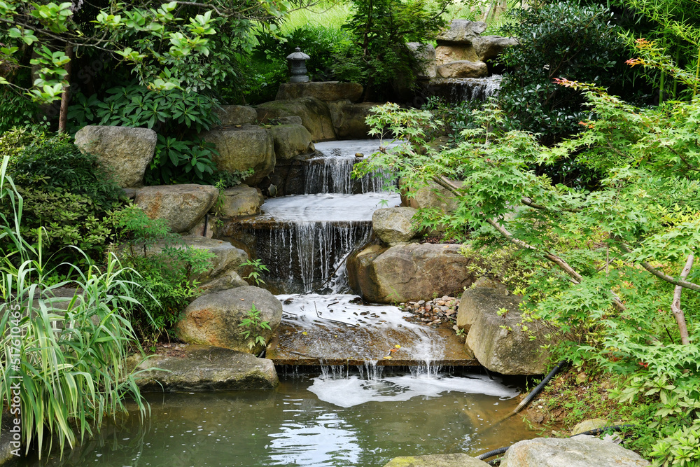 a waterfall on a rockery in a garden a waterfall on a rockery in a garden