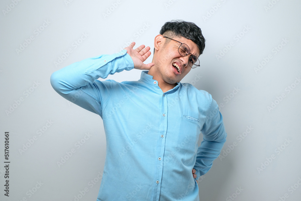 Young handsome asian man stretching back, tired and relaxed, sleepy and yawning for early morning Young handsome asian man stretching back, tired and relaxed, sleepy and yawning for early morning