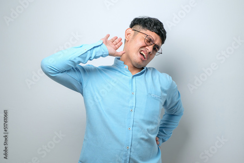 Young handsome asian man stretching back, tired and relaxed, sleepy and yawning for early morning