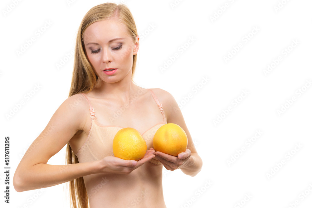 Woman small boobs holds big orange fruits Woman small boobs holds big orange fruits