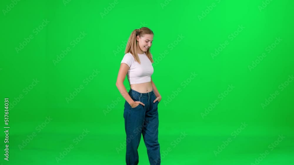 Female walking down the street on a green background, a passerby on a walk, chroma key template, young woman in a white t-shirt and blue jeans, citizen. Female walking down the street on a green background, a passerby on a walk, chroma key template, young woman in a white t-shirt and blue jeans, citizen.
