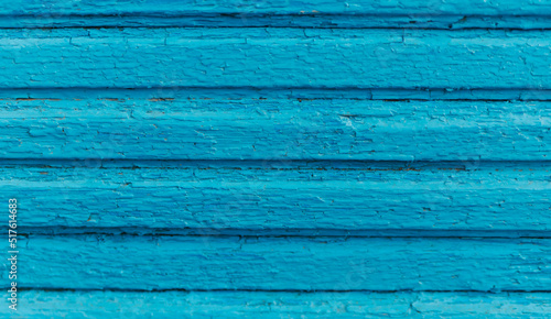 Wooden boards painted in blue. Rough and cracked surface. Old wood and paint.Background and texture.