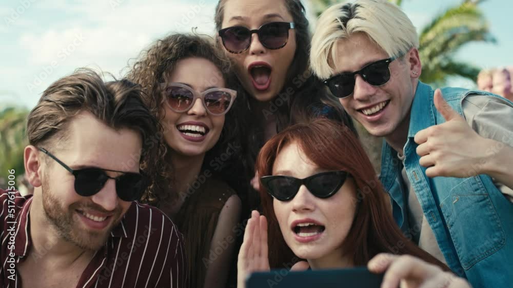 Group of caucasian friends making funny faces for a selfie on music festival. Shot with RED helium camera in 8K. Group of caucasian friends making funny faces for a selfie on music festival. Shot with RED helium camera in 8K.