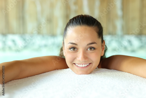Portrait of a beautiful woman looking at you in spa pool