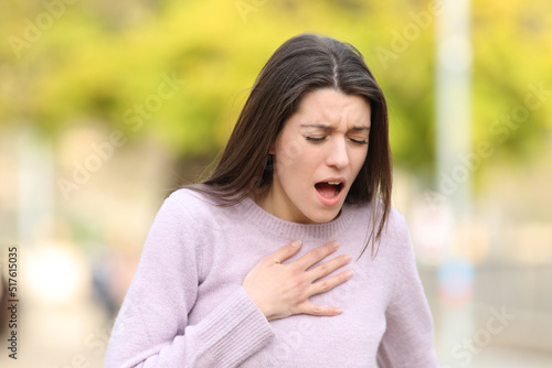 Stressed teen having breath problems in a park