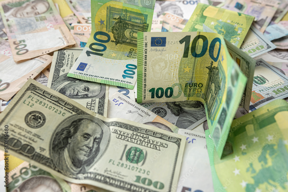 A lot of different money hryvnia euro and dollar bills on desk. exchange or saving concept A lot of different money hryvnia euro and dollar bills on desk. exchange or saving concept