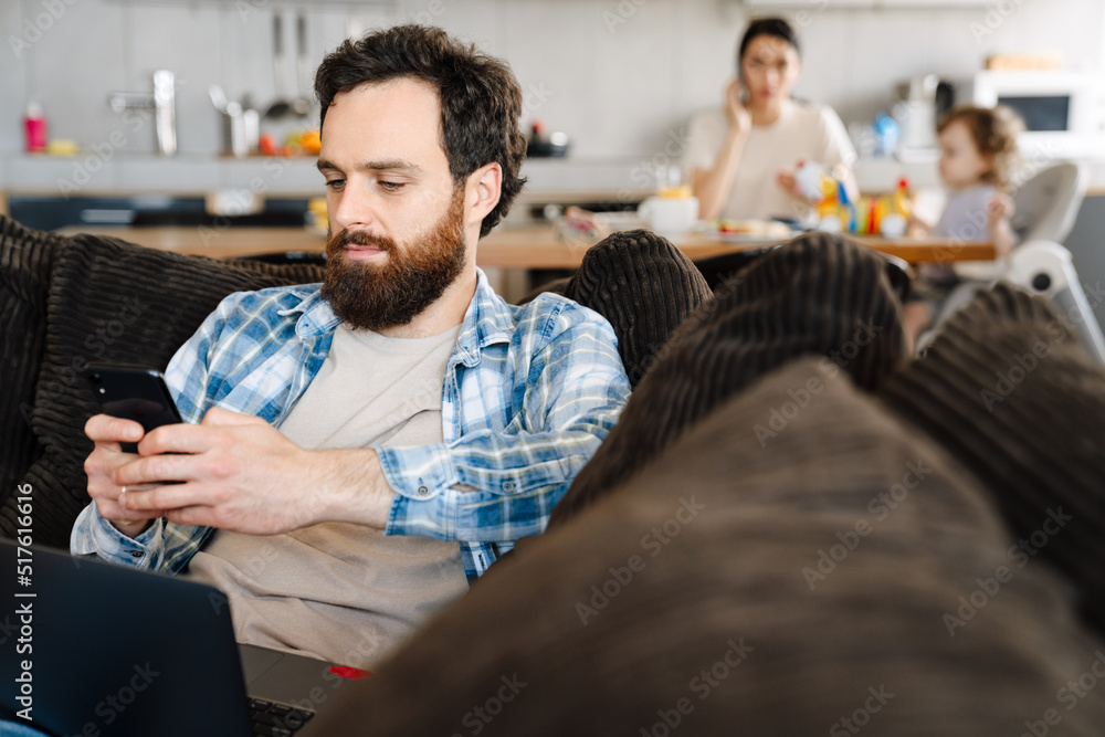 Middle aged brearded man working on laptop computer Middle aged brearded man working on laptop computer