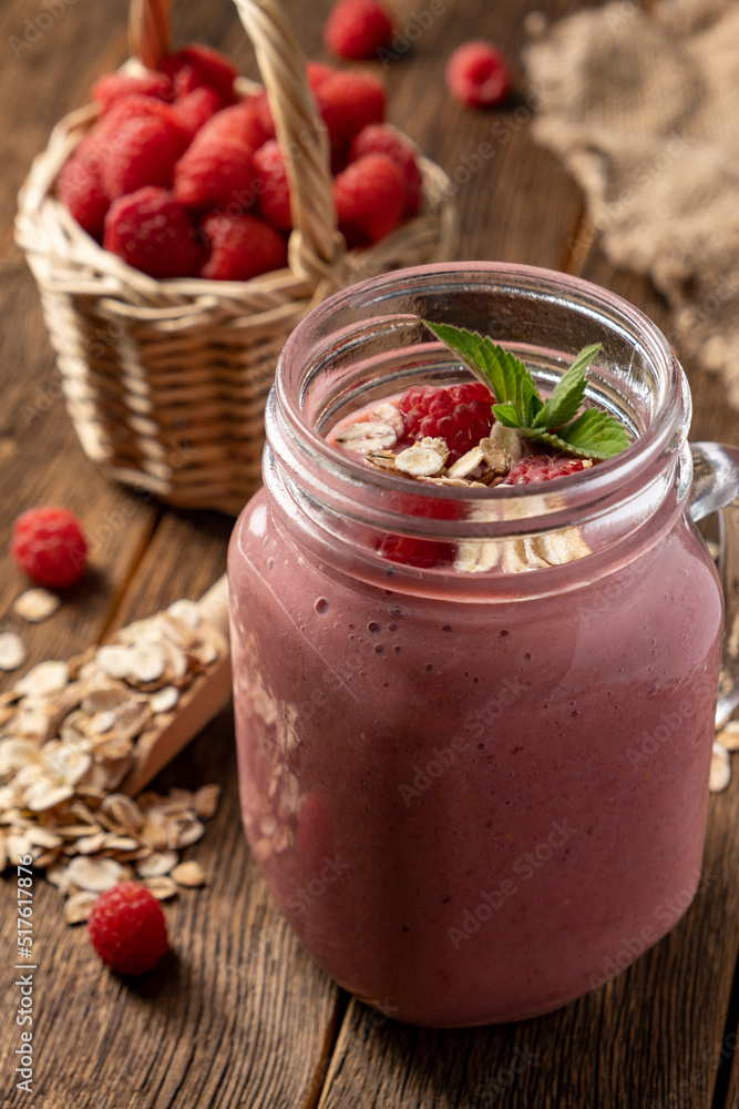 Smoothie with raspberry, oatmeal and mint in a jar on rustic wooden background. Smoothie with raspberry, oatmeal and mint in a jar on rustic wooden background.