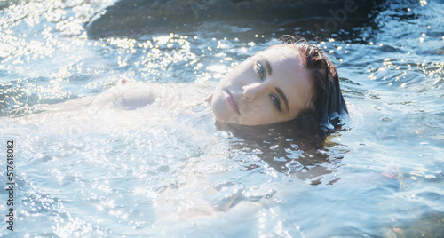 Beautiful topless woman on a beach in a sunny day.
