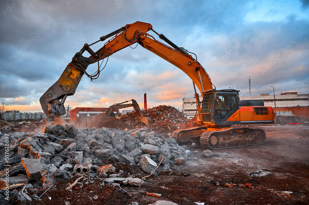 Excavator with concrete crusher on rig at demolition site Excavator with concrete crusher on rig at demolition site