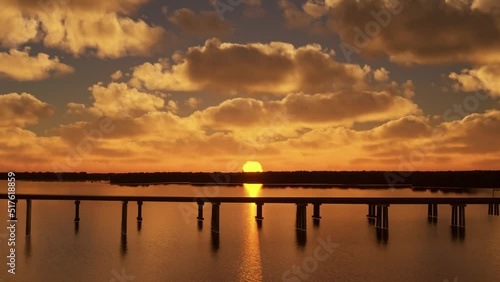 Aerial drone footage of the Chesapeake Bay Bridge in Maryland at sunset with a sideways movement of the bridge with the sun in the background. United States of America photo