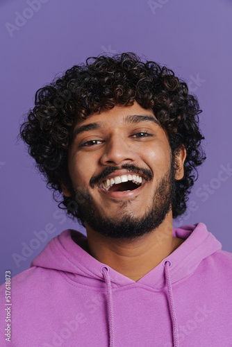 Portrait of young indian handsome curly happy smiling man