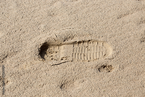footprints of men's shoes in the sand