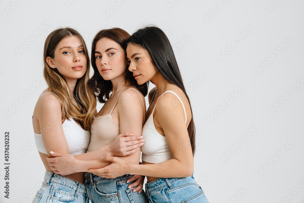 Three gorgeous brunette women posing at camera together Three gorgeous brunette women posing at camera together