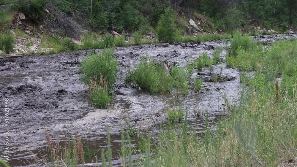 After a mudslide from a burn scar near Glen Haven Colorado the Big Thompson river runs black with mud and ash. July 15, 2022. After a mudslide from a burn scar near Glen Haven Colorado the Big Thompson river runs black with mud and ash. July 15, 2022.