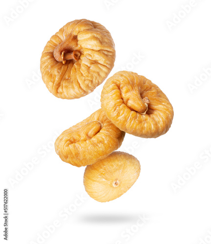 Fotografie Delicious dried figs in the air closeup on a white background