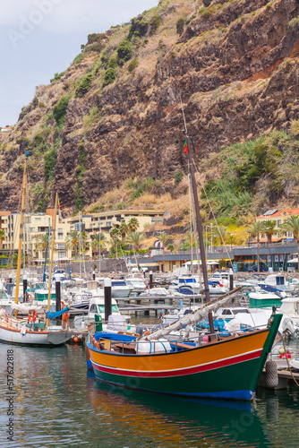 Sailing yachts and boats are moored in marina of Calheta. Madeira