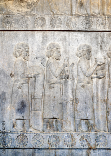 Ancient wall with bas-relief with assyrian foreign ambassadors with gifts and donations, Persepolis, Iran