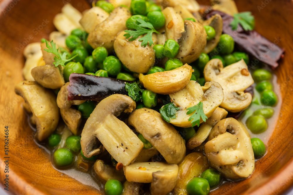 Mushroom and Pea Curry with Roasted Garlic, Indian food served in a bowl Mushroom and Pea Curry with Roasted Garlic, Indian food served in a bowl