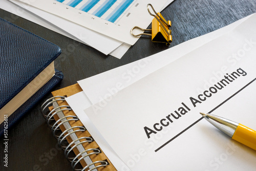 Documents about accrual accounting near notepad and pen. photo