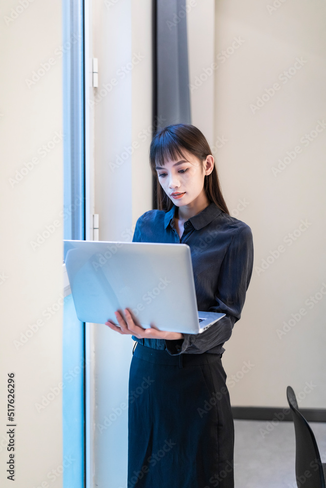 Working business women in conference rooms with black shirts and skirts Working business women in conference rooms with black shirts and skirts