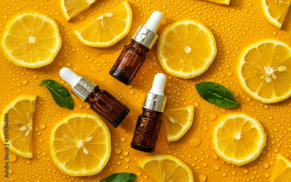 Bottle of cosmetics and drops of liquid, moisturizing lemon. Hyaluronic acid. Selective focus. Bottle of cosmetics and drops of liquid, moisturizing lemon. Hyaluronic acid. Selective focus.