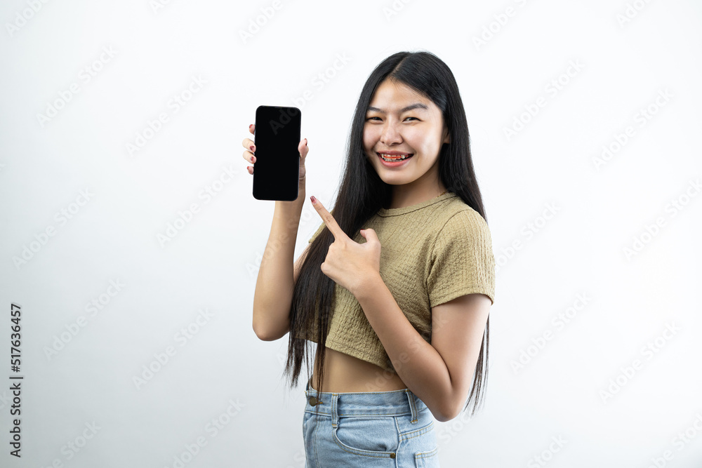 Young Asian teen woman showing smart phone isolated on white background. Young Asian teen woman showing smart phone isolated on white background.