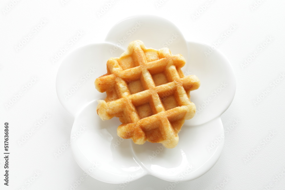 Belgium waffle on white plate for sweet breakfast Belgium waffle on white plate for sweet breakfast