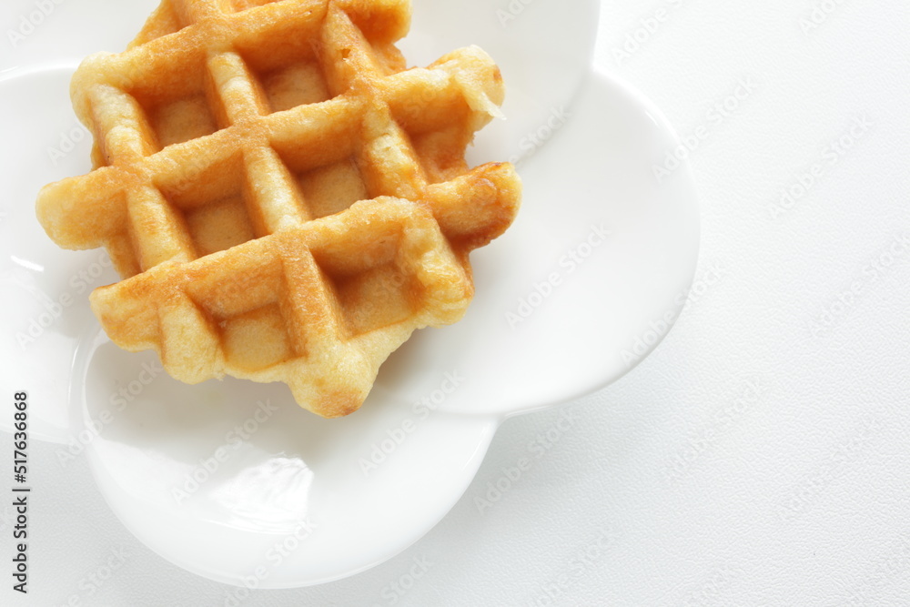 Belgium waffle on white plate for sweet breakfast Belgium waffle on white plate for sweet breakfast