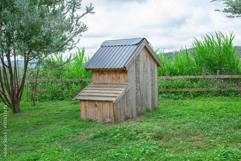 Wooden chicken coop in farm yard background Wooden chicken coop in farm yard background