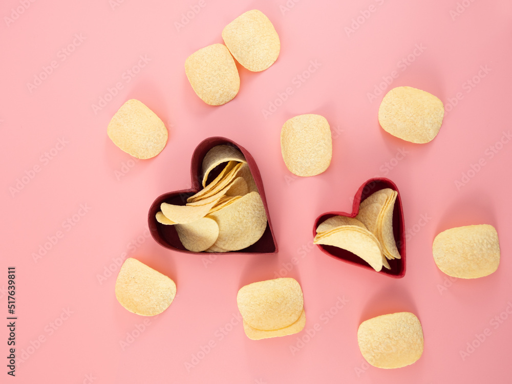 Chips in a box on a pink background. Chips in a box on a pink background.