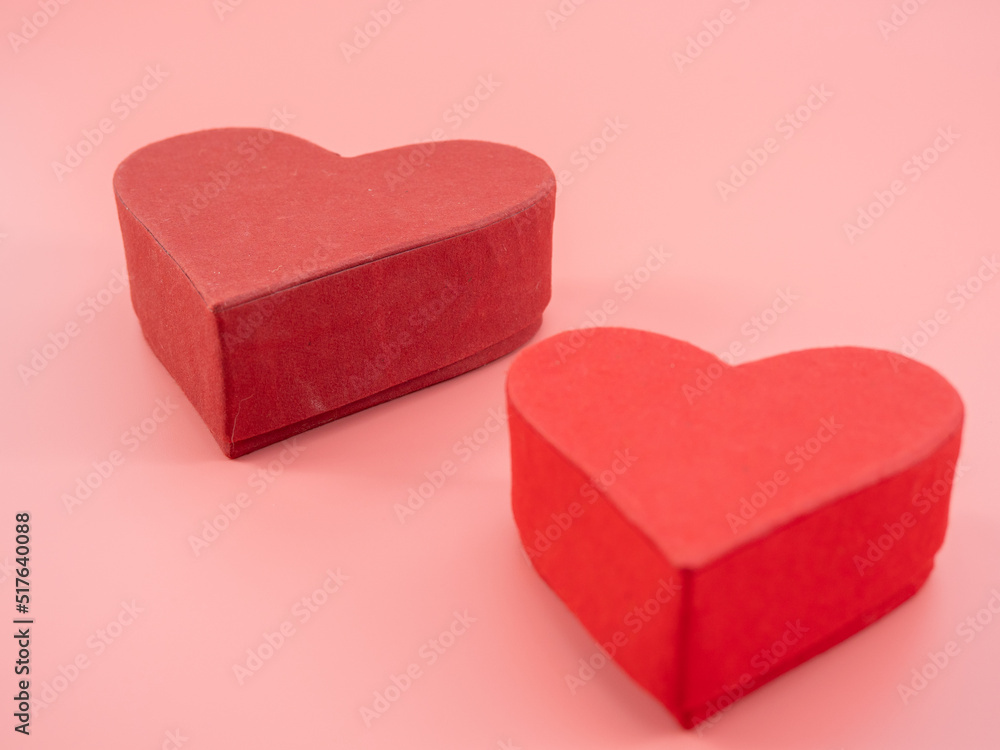 Heart shaped boxes on a pink background.