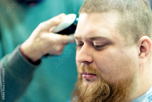 Fototapeta Naklejka Na Ścianę i Meble -  Barber's hand trimming a male's hair.
