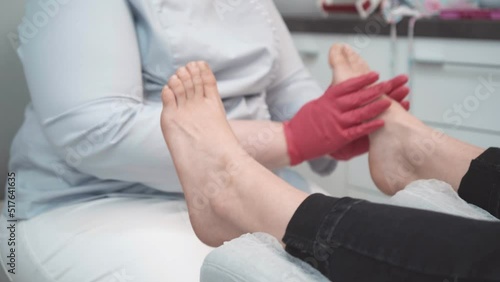 Close up on a podiatrist hands treating feet during procedure